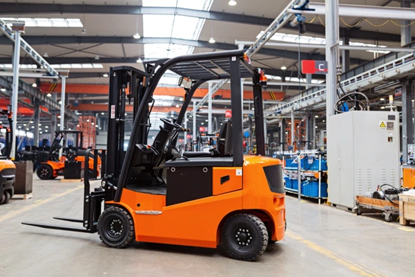 A new Toyota counterbalance forklift parked inside a clean, modern factory A new Toyota counterbalance forklift parked inside a clean, modern factory
