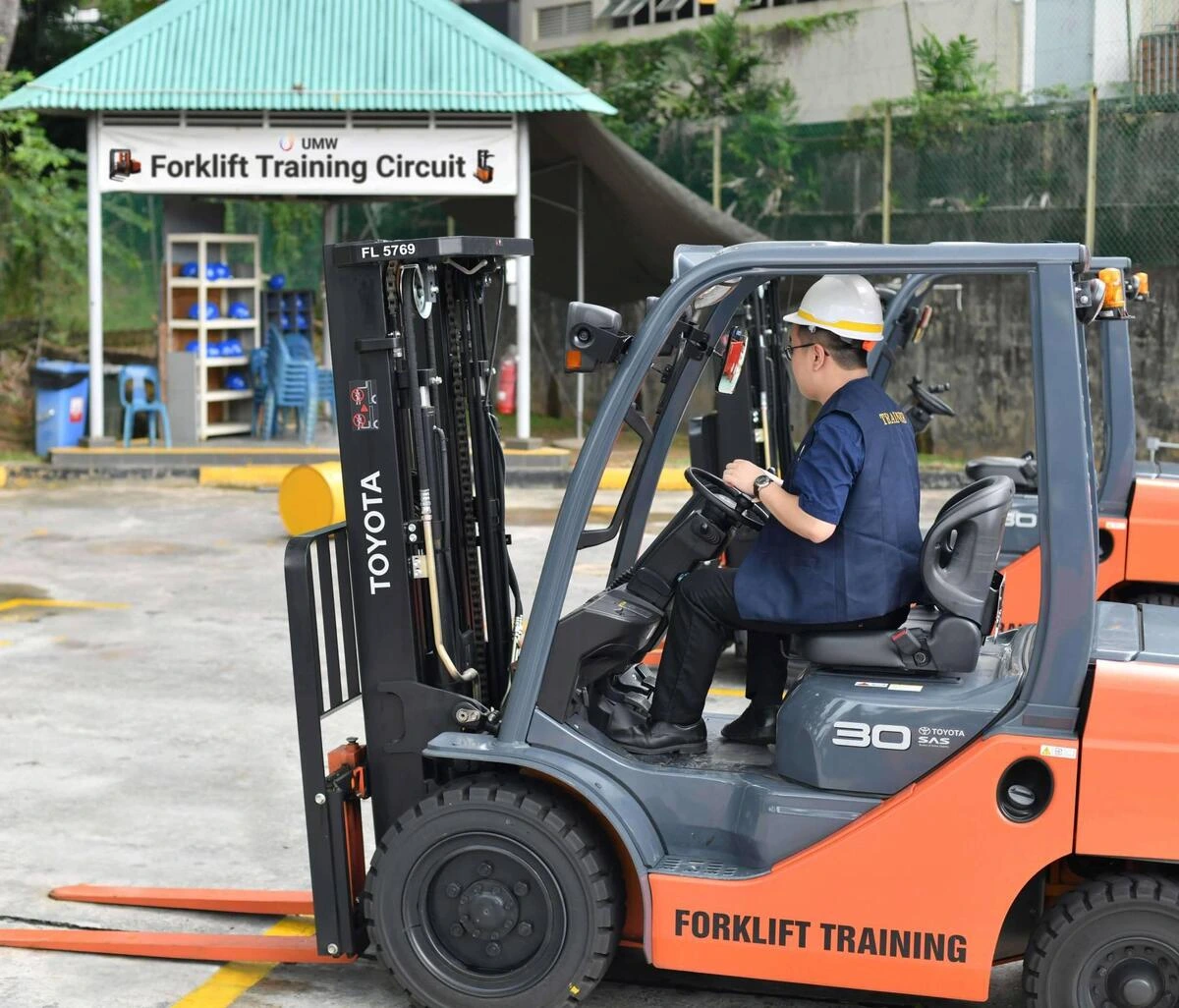 Forklift training at UMW Singapore circuit Trainee operating a Toyota forklift at a forklift training circuit in Singapore